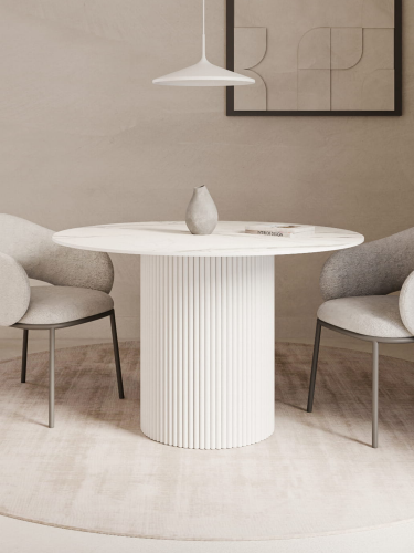 Biały stół do jadalni, okrągły blat i ryflowana noga, idealny do jasnych, przestronnych wnętrz